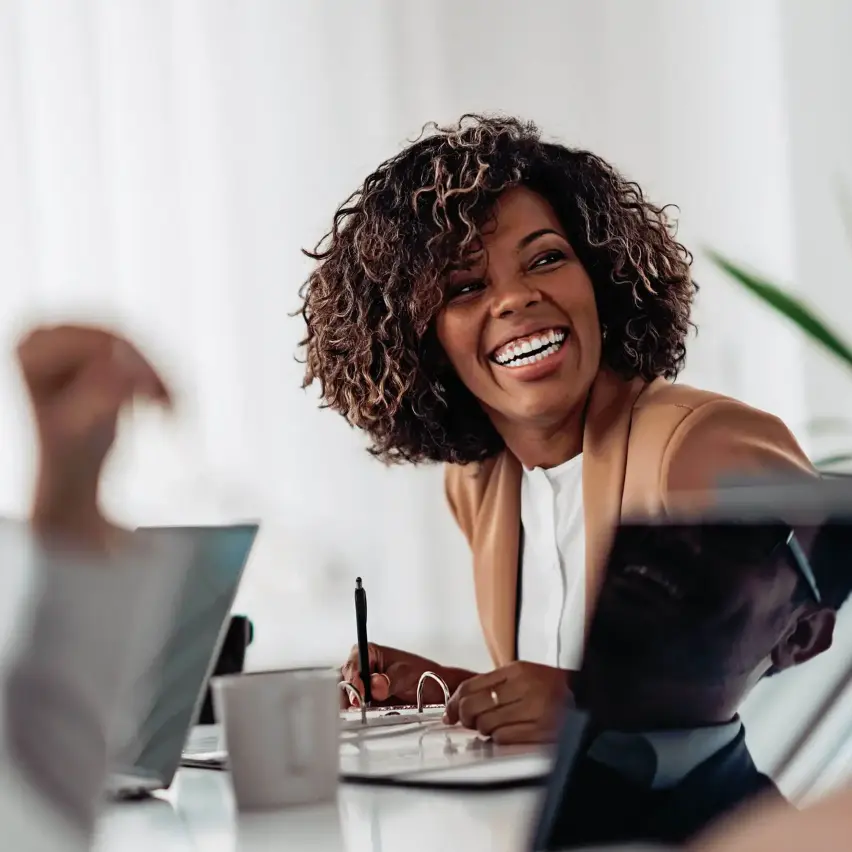 Black professional woman smiling at a desk